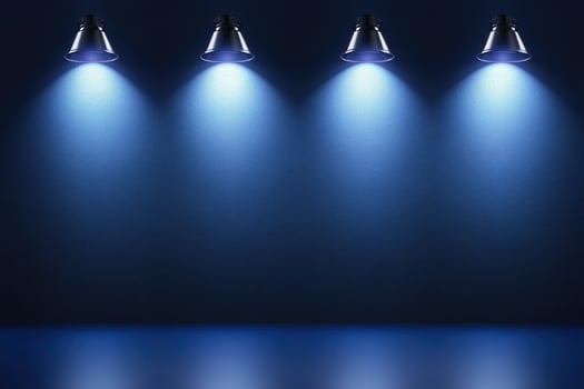 Three blue spotlight lights on a dark background photo