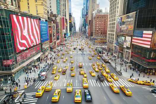 A busy city street with many yellow cabs photo