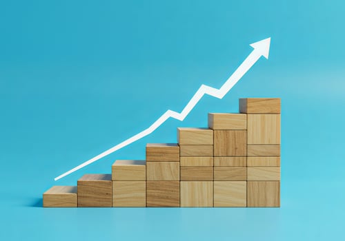 A wooden block with an upward arrow going up photo