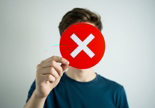 A man holding up a red cross sign photo