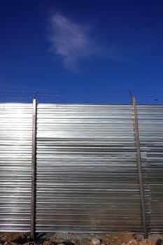 Metallic Barrier Against Clear Sky photo
