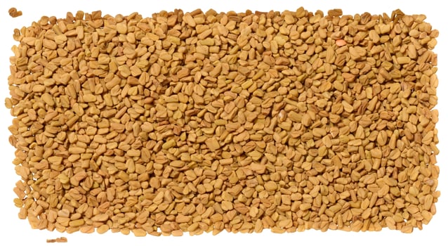 Detailed, top down close up of a dense pile of dry, light brown fenugreek seeds photo
