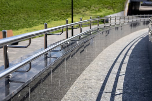 Long row of polished stainless steel ramp for going up or down photo