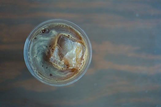 Iced Americano or black coffee with a big of square ice cubes photo
