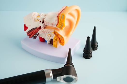 Otoscope with ear model for otolaryngologist or ENT physician doctor examining senior patient ear, hearing loss p photo