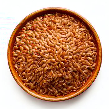 A bowl full of brown flax seeds on a white background photo