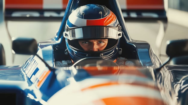 driver in helmet sits behind the wheel of a car close-up and looks at the camera photo