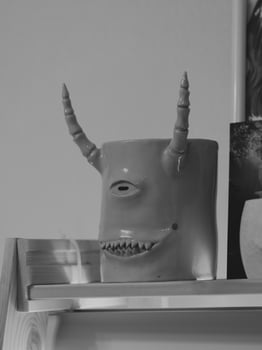 A Surreal Monster is Peering Mysteriously from Inside a Refrigerator in Black and White photo