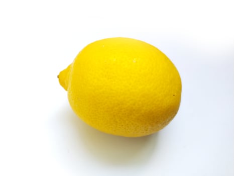 Vibrant yellow lemon isolated on white. Perfect for food blogs, recipes, health wellness, or refreshing summer themes. Represents freshness, zest, and vitamin C. Clean, minimalist style. photo