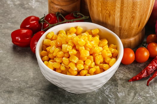 Corn in a bowl with tomatoes and peppers photo