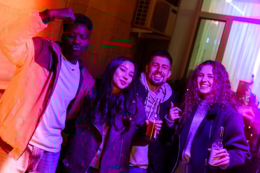Friends enjoying a lively night out at a modern lounge with colorful lighting in the background photo