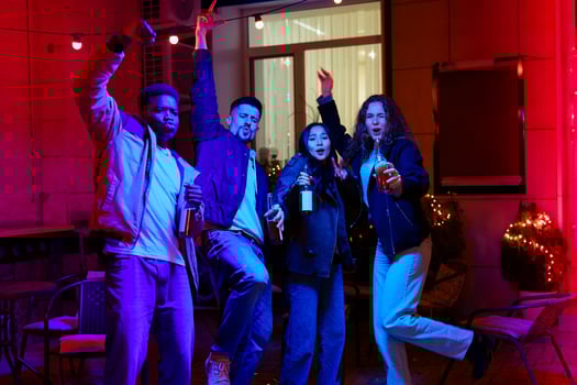 Friends celebrating together at a vibrant outdoor gathering during a lively night party photo