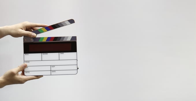 Digital film slate for filmmaker in set. Hand hitting timecode clapperboard or movie slate for Production. Digi number clapper board or film slates action on set. Tools in modern cine industry photo