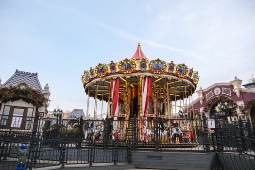 Moscow, Russia, 31.03.2025 A carousel with a red and white top is surrounded by a fence photo