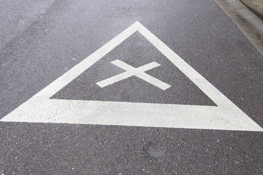 road sign of equal intersection painted on asphalt photo