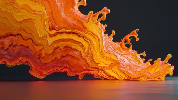 A large orange liquid flowing over a black surface photo