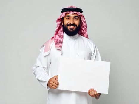 Smiling Saudi Man Holding Blank Sign for Message or Advertisement photo
