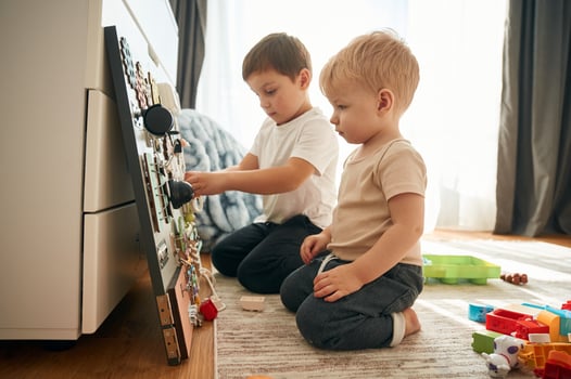Two ,brothers ,are playing with constructor with bunch of objects at home photo