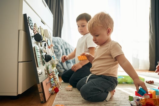 Two brothers, are playing with constructor with bunch of objects at home photo