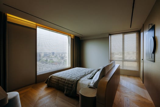 A spacious bedroom featuring a large bed and an oversized window photo