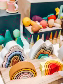 Colorful wooden rainbow toys and shapes for playful decor in playroom setting photo