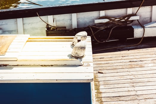Boat deck with nautical ropes and wooden planks in sunlight background photo