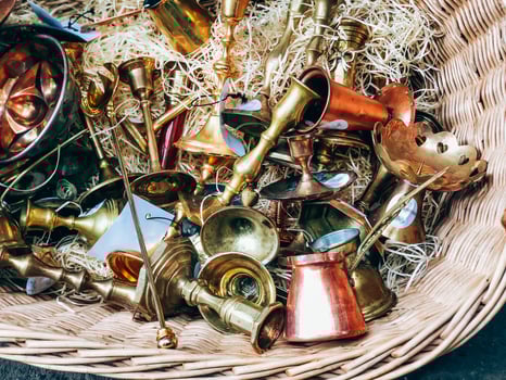 Antique brass and copper musical instruments in wicker basket, detailed texture photo