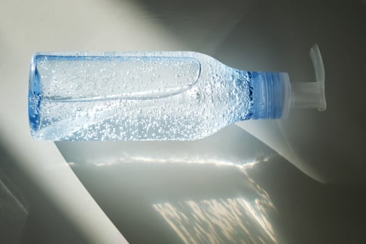 Tube of micellar gel in a ray of sunlight. photo