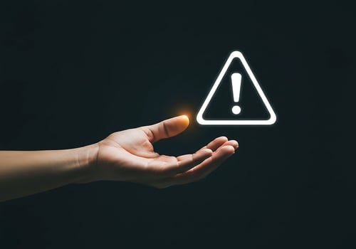 A hand holding a warning sign with a glowing light photo