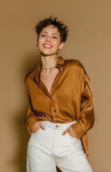 A woman in a brown shirt and white pants photo
