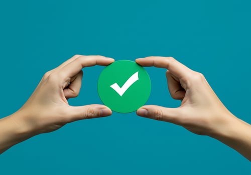 Hands holding green check mark on blue background photo