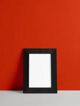 A black square frame on a red wall photo