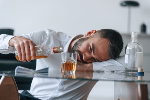 Life crisis... With whiskey. Upset young man drinker alcoholic is indoors photo