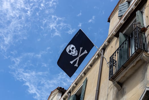 Pirate Flag Flying from Old Building photo