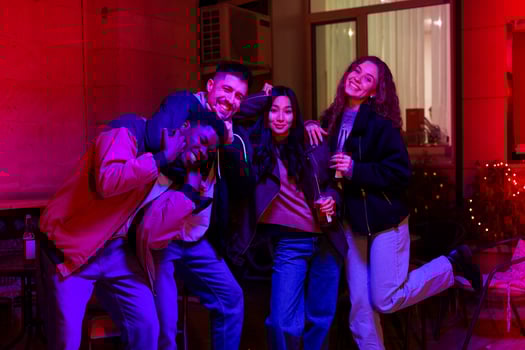 Friends celebrating together in vibrant indoor setting during nighttime party photo