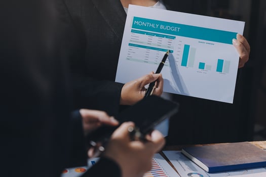 Businessman holding a paper with a graph on it photo