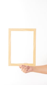 Hand holding thin wood photo frame isolated on white background