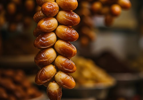 Hanging Fresh Dates at Market Stall Delicious and Ready to Eat photo
