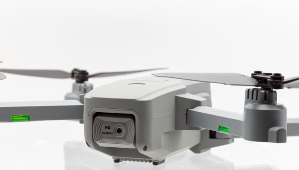 Drone with black propellers ready for flight isolated on white background. Close-up. photo