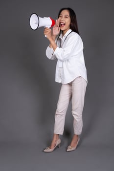 Full Body Portrait of a Young Businesswoman with Megaphone photo