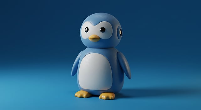A blue penguin toy standing on a blue background photo