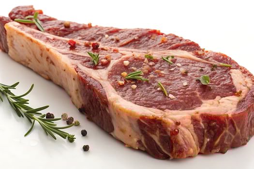 A piece of meat with herbs and spices photo