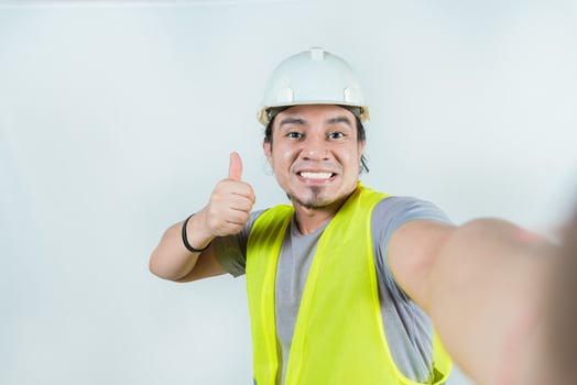 Self portrait of smiling engineer gesturing OK. Handsome engineer, smiling at the camera, showing approval photo
