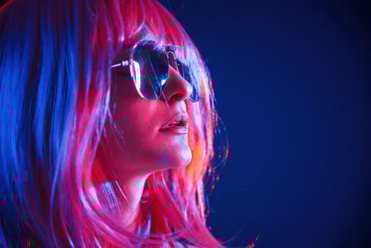 White hair, of, medium ,length. Woman is in studio with neon colors photo