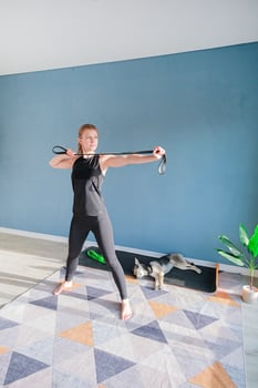 woman doing exercises for arms with resistance band photo