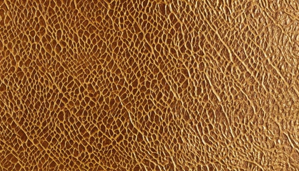 Textured gold leather surface pattern close-up abstract design photo