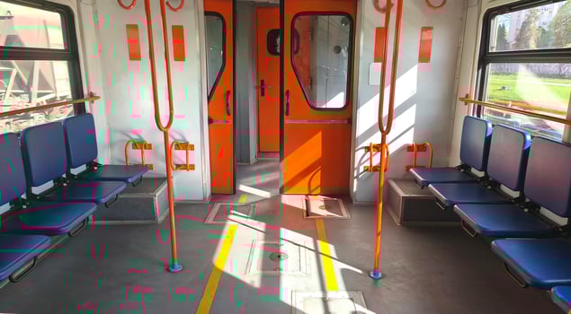 Empty carriage with blue seats and orange handrails of a city or intercity electric train. City transport, carriage interior photo