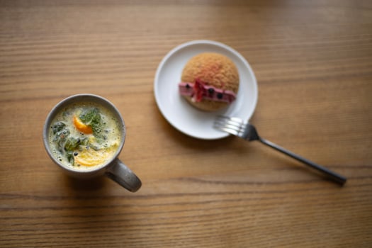 fruit tea with orange and cake with pink cream, top view photo