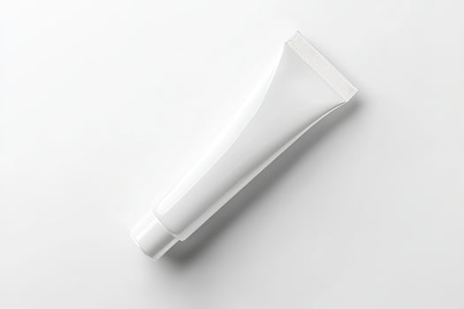 A tube of toothpaste on a white surface photo