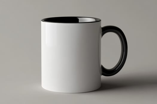 A white and black coffee mug on a gray background photo